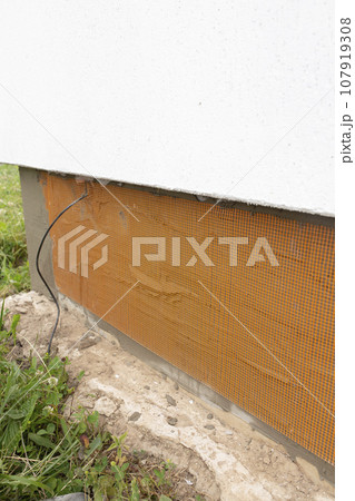 External works on insulation and finishing of the foundation. 107919308