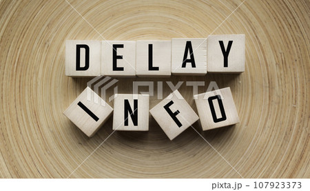 DELAY INFO, text on wooden cubes. Information about the delay of something or someone DELAY INFO, text on wooden cubes. Information about the delay of something or someone 107923373