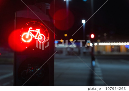 Bicycle stop red warning lamp sign on traffic light road highway driveway drive crossroad intersection evening dark time german city. Bike forward movement prohibited on semaphore signal city street 107924268