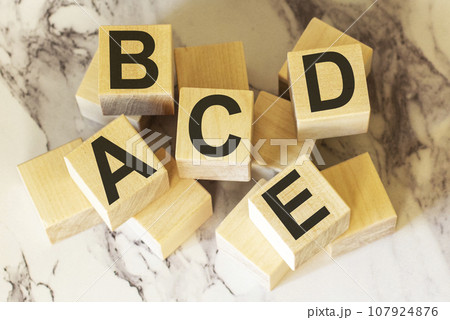 Letters of the alphabet on wooden blocks and a light background 107924876