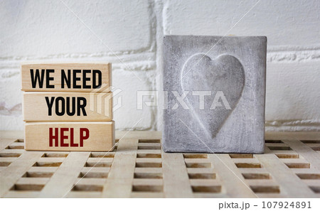 Wooden blocks with words 'WE NEED YOUR HELP'. Business concept Wooden blocks with words 'WE NEED YOUR HELP'. Business concept 107924891
