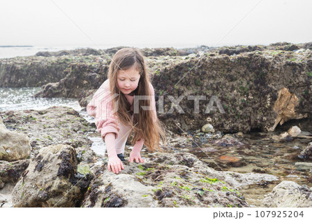 Little girl Eastbourne, East Sussex. Beach and sea in foggy morning 107925204