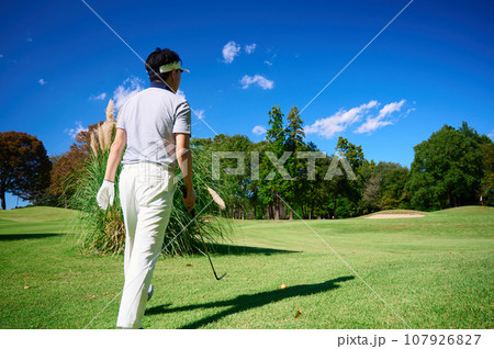 青空の中ゴルフをする40代男性 107926827