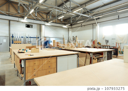 Interior of large workshop of contemporary furniture factory Interior of large workshop of contemporary furniture factory 107933275