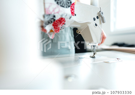 Sewing machine in textile factory close up Sewing machine in textile factory close up 107933330
