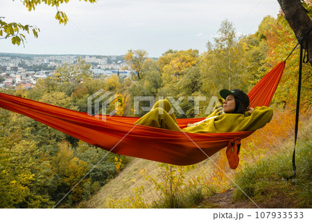 chilling woman laying down in hammock chilling woman laying down in hammock 107933533