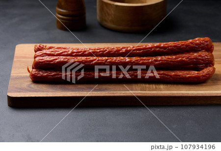 Traditional Polish thin smoked sausages on a black background Traditional Polish thin smoked sausages on a black background 107934196