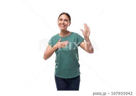 charming cute friendly slim young brunette woman dressed in a green t-shirt smiling on a white charming cute friendly slim young brunette woman dressed in a green t-shirt smiling on a white 107935042
