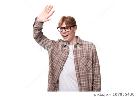young charming student guy with red hair in glasses looks friendly 107935430