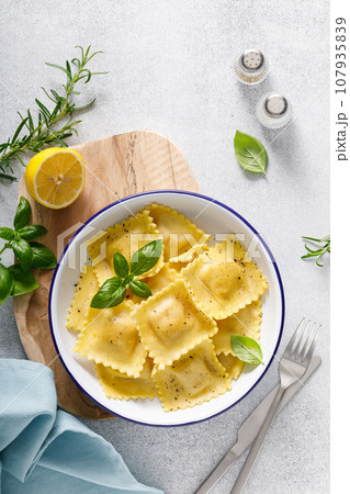 Ravioli with ricotta cheese and fresh basil, top view Ravioli with ricotta cheese and fresh basil, top view 107935839