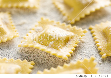 Cooking ravioli on a floured kitchen table Cooking ravioli on a floured kitchen table 107935851