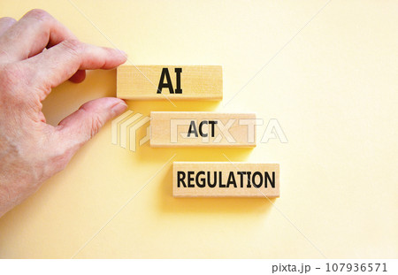 AI act regulation symbol. Concept words AI artificial intelligence act regulation on wooden block. Beautiful white background. Businessman hand. Business AI act regulation concept Copy space AI act regulation symbol. Concept words AI artificial intelligence act regulation on wooden block. Beautiful white background. Businessman hand. Business AI act regulation concept Copy space 107936571