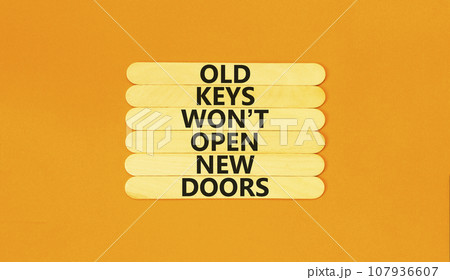 Old keys do not open new doors symbol. Concept words Old keys do not open new doors. Beautiful orange table orange background. Business, popular quotation old key new door concept. Copy space. Old keys do not open new doors symbol. Concept words Old keys do not open new doors. Beautiful orange table orange background. Business, popular quotation old key new door concept. Copy space. 107936607