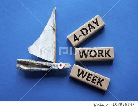 4-day work week symbol. Concept words 4-day work week on wooden blocks. Beautiful blue background with boat. Business and 4-day work week concept. Copy space 4-day work week symbol. Concept words 4-day work week on wooden blocks. Beautiful blue background with boat. Business and 4-day work week concept. Copy space 107936947
