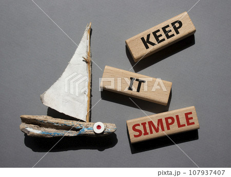 Keep it Simple symbol. Concept words Keep it Simple on wooden blocks. Beautiful grey background with boat. Business and Keep it Simple concept. Copy space. Keep it Simple symbol. Concept words Keep it Simple on wooden blocks. Beautiful grey background with boat. Business and Keep it Simple concept. Copy space. 107937407