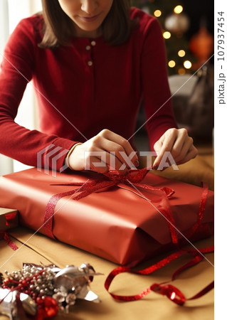 Close-up of adult person hands wrapping a Christmas gift. AI-generated content 107937454