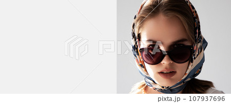 Fashionable girl in sunglasses and scarf. French Fashionable girl in sunglasses and scarf. French 107937696