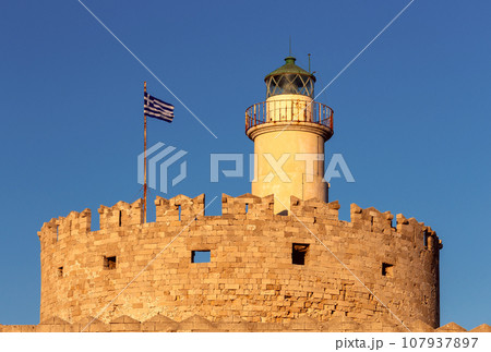 Old stone lighthouse on the breakwater in Rhodes. Old stone lighthouse on the breakwater in Rhodes. 107937897