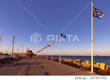 Old stone lighthouse on the breakwater in Rhodes. 107937901