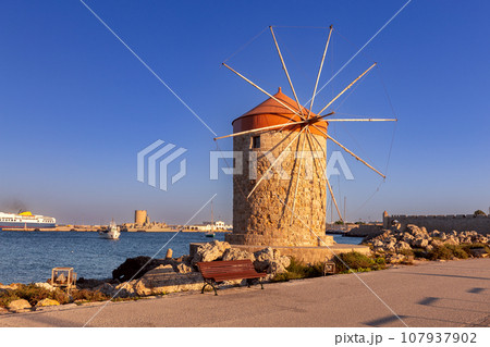 Old medieval windmills on the Rhodes breakwater. 107937902