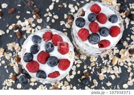 Muesli with raspberries and blueberries 107938371