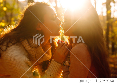 Portrait of happy mother and daughter in autumn forest at sunset. . Autumn women. 107939138