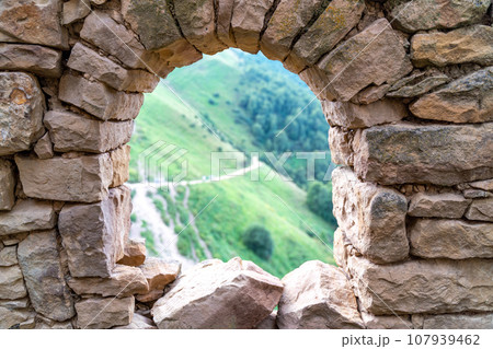 Dagestan Gamsutl. Ancient ghost town of Gamsutl old stone houses in abandoned Gamsutl mountain village in Dagestan, Abandoned etnic aul, summer landscape. 107939462