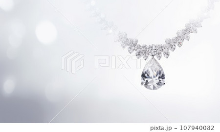 A stunning diamond necklace on a white background. The necklace has a V-shaped design with small diamonds and a large teardrop diamond in the center. 107940082