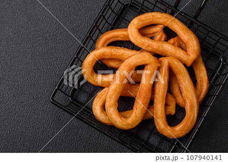 Delicious sweet churos with powdered sugar and cream inside 107940141