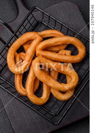 Delicious sweet churos with powdered sugar and cream inside Delicious sweet churos with powdered sugar and cream inside 107940146