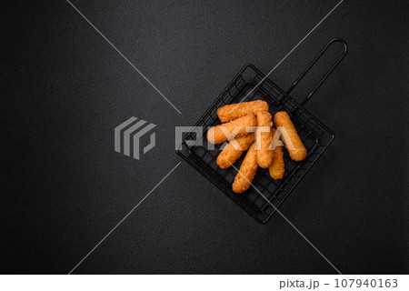 Delicious crispy cheese sticks with mozzarella, salt and spices, breaded Delicious crispy cheese sticks with mozzarella, salt and spices, breaded 107940163