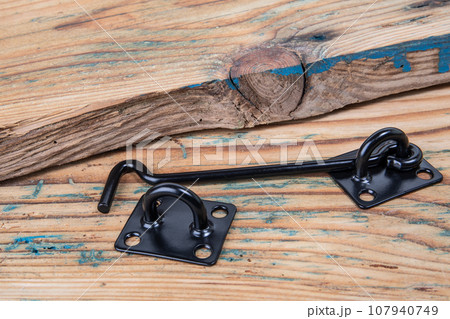Black door hook on wood texture background Black door hook on wood texture background 107940749