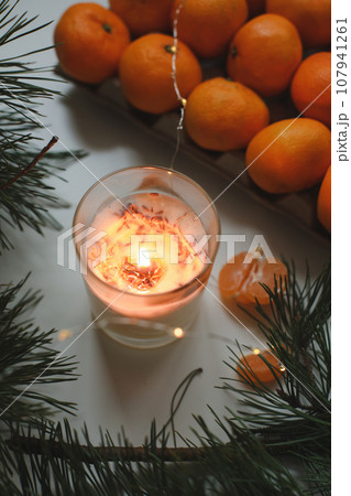 Christmas background with fir tree branches and tangerines. Merry Christmas and Happy New Year Greeting Card 107941261