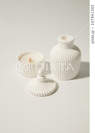 Home made candle in white ceramic pot on a white background ,a vase with a candle Home made candle in white ceramic pot on a white background ,a vase with a candle 107941305