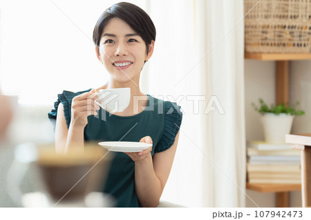 リビングでコーヒーを飲む女性 リビングでコーヒーを飲む女性 107942473