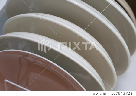 Clean plates in dish drying metal rack Clean plates in dish drying metal rack 107943722