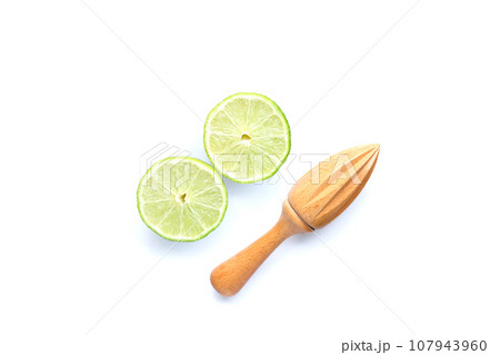 Fresh lime with wooden juicer on white background. Copy space 107943960