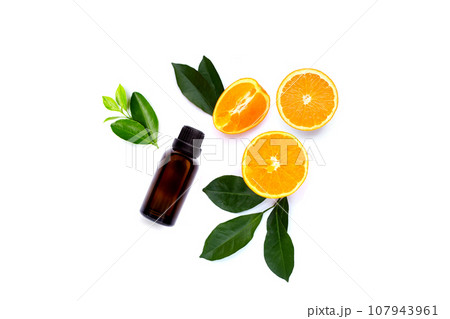 Essential oil with fresh orange fruit with green leaves on white background. Essential oil with fresh orange fruit with green leaves on white background. 107943961
