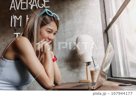 Portrait of happy freelance woman working creative in the cafe. Portrait of happy freelance woman working creative in the cafe. 107944177