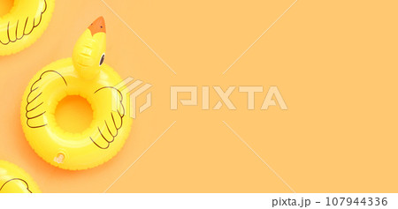 Inflatable of yellow duck on yellow background. Summer background concept Inflatable of yellow duck on yellow background. Summer background concept 107944336