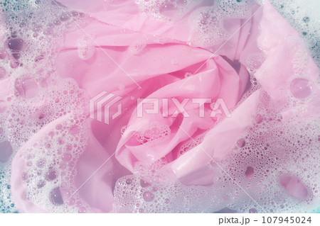 Clothes soak in powder detergent water dissolution, washing colored clothes Clothes soak in powder detergent water dissolution, washing colored clothes 107945024