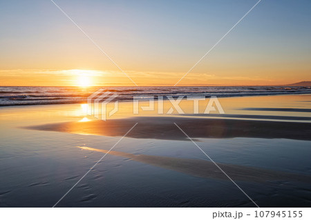 Atlantic ocean sunset with surging waves at Fonte da Telha beach, Costa da Caparica, Portugal 107945155