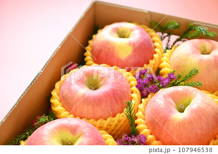 beautiful apple in the box on pink backgrond, healthy fruit beautiful apple in the box on pink backgrond, healthy fruit 107946538