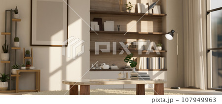 A modern spacious living room with a coffee cup on a carpet, a floor lamp, a cactus shelf, and decor 107949963