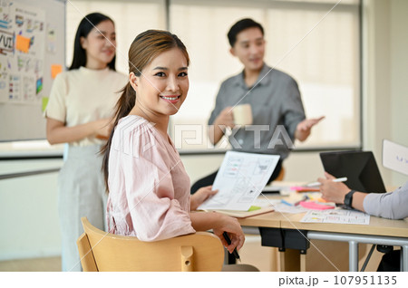 An attractive millennial Asian female developer is in a meeting with her colleagues 107951135