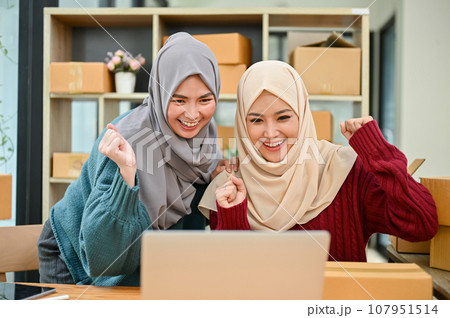 Young Muslim team of online business celebrating together after receiving big orders Young Muslim team of online business celebrating together after receiving big orders 107951514
