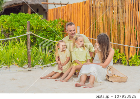 A joyful family, two girls, dad, and a pregnant mom, bask in tropical beach bliss, celebrating a radiant pregnancy amidst paradise A joyful family, two girls, dad, and a pregnant mom, bask in tropical beach bliss, celebrating a radiant pregnancy amidst paradise 107953928