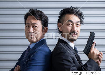 カッコイイビジネスマンや刑事ドラマや映画ののバディのイメージ シャッターの前に立つ クローズアップ カッコイイビジネスマンや刑事ドラマや映画ののバディのイメージ シャッターの前に立つ クローズアップ 107954308