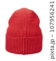Beautiful knitted winter hat in bright red color made of wool yarn, isolated on a white background. Rear view. 107956241