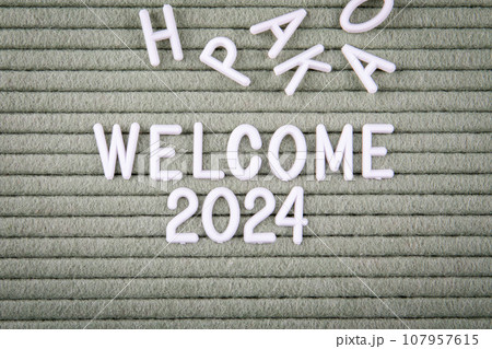 WELCOME 2024 Concept. White letters of the alphabet on a green background 107957615